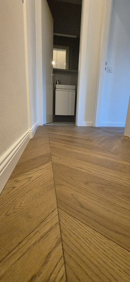Parquet chevron en chêne naturel dans un couloir